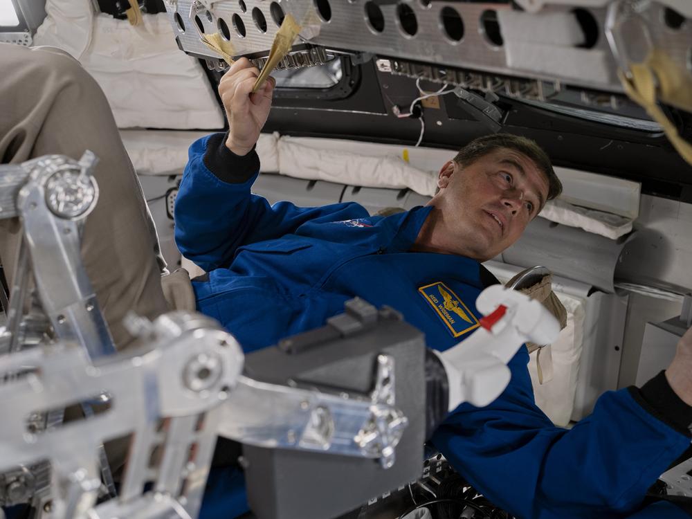 Reid Wiseman demonstrates what he and his crew will be doing inside the Orion spacecraft during their mission.