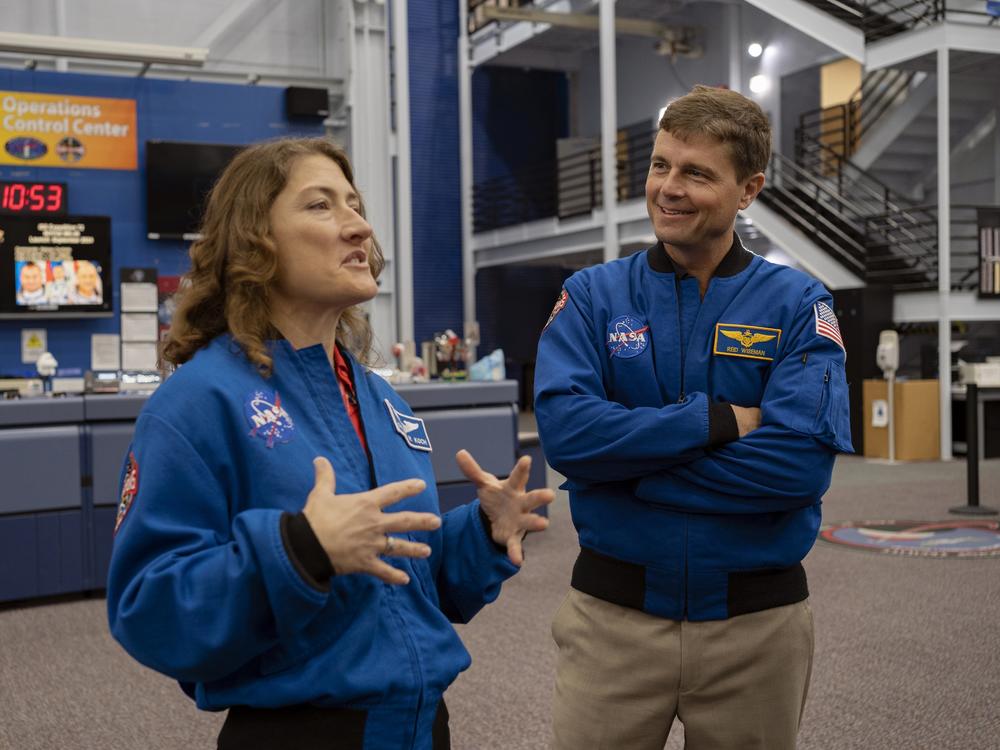 Christina Koch runs through the plans as Reid Wiseman listens.