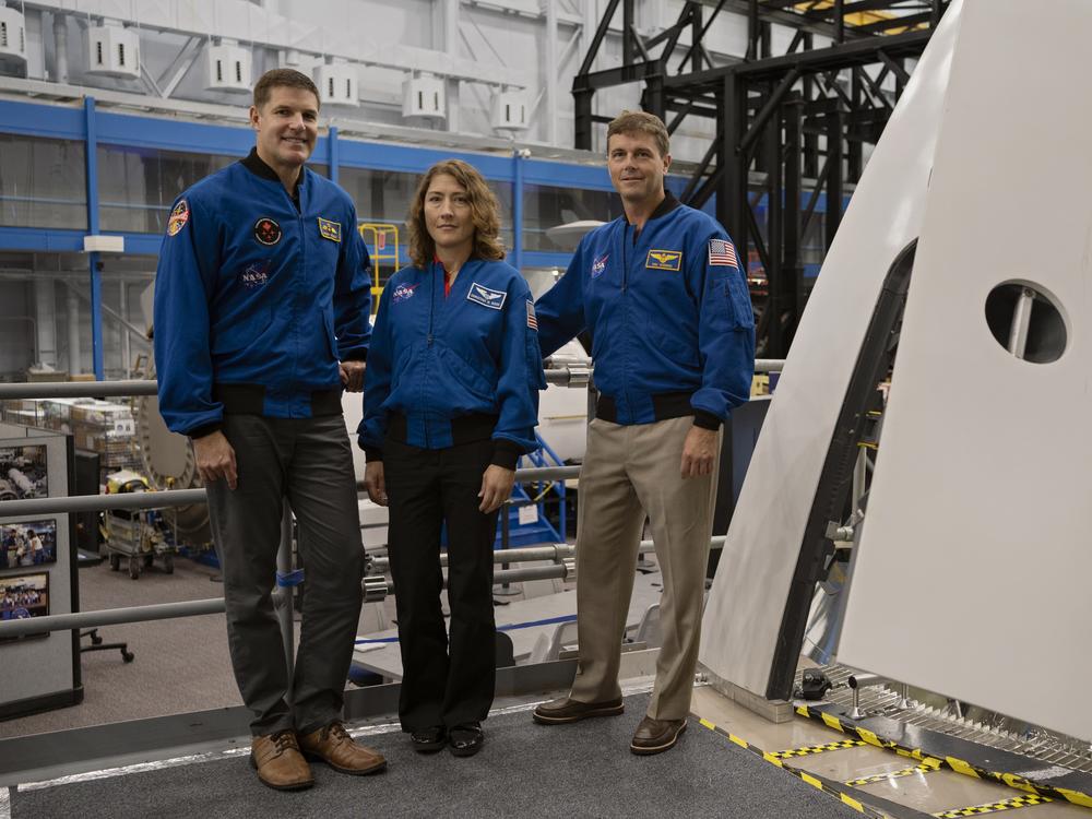 From left to right: Astronauts Jeremy Hansen, Christina Koch and Reid Wiseman with the Orion spacecraft mockup.