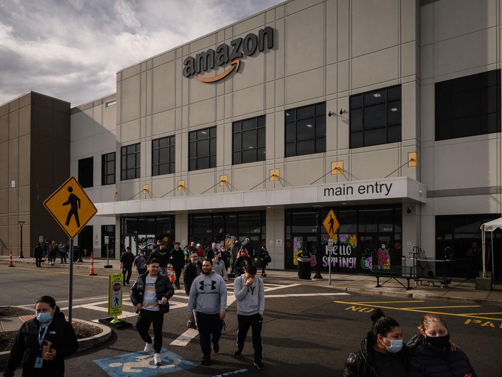 Workers walk to cast their votes over whether or not to unionize, outside an Amazon warehouse in Staten Island, N.Y., on March 25, 2022.