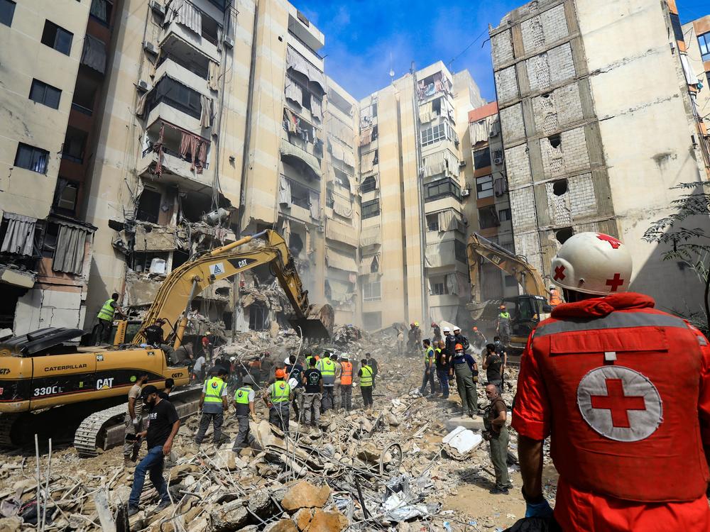Rescuers sift through the rubble at the scene of an Israeli strike that targeted Beirut's southern suburbs a day earlier, as search and rescue operations continue on Sept. 21.
