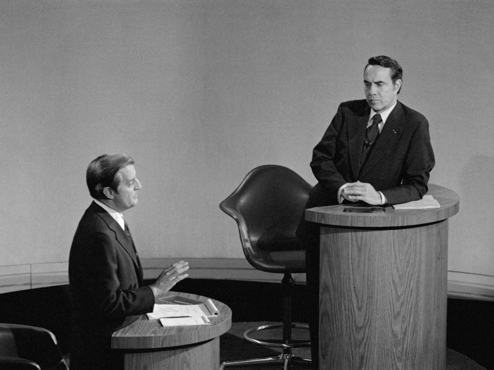GOP vice presidential candidate Robert Dole (R) listens as his opponent, Democrat Walter Mondale, makes a point during their nationally televised debate at Houston's Alley Theater on Oct. 16, 1976.