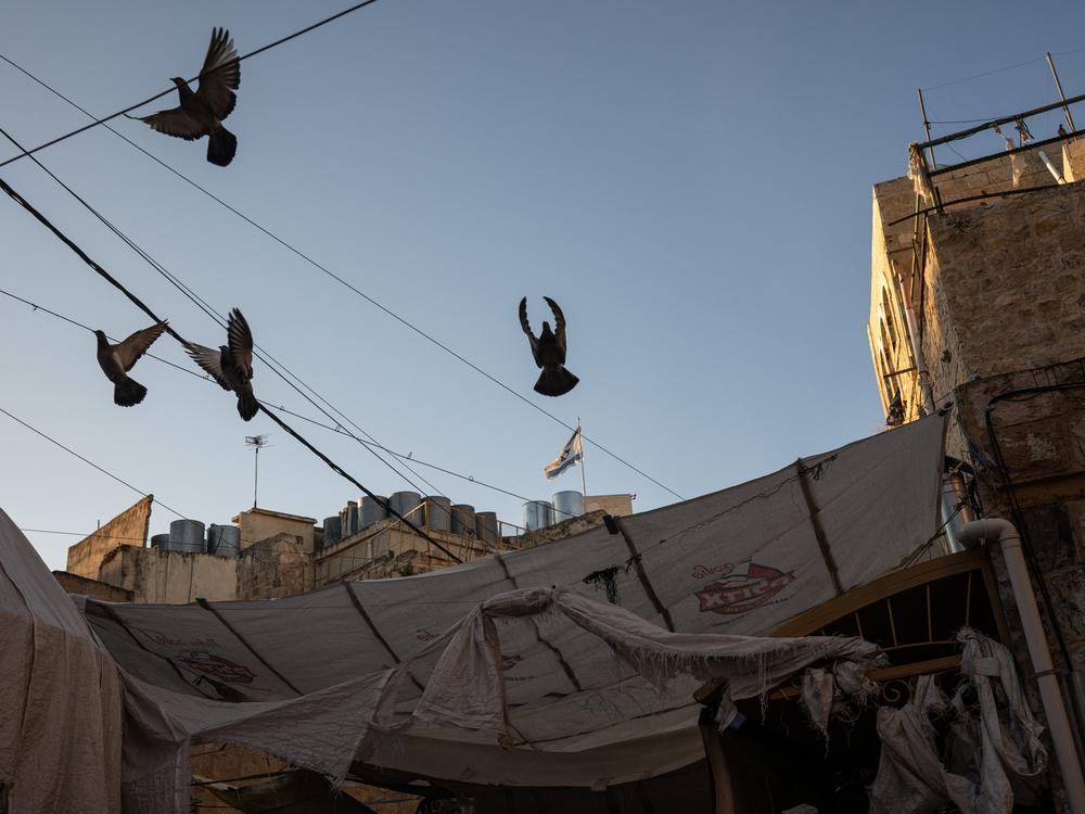 Buildings in an Israeli settlement stand above a Palestinian street in the old city of Hebron in the occupied West Bank in February.