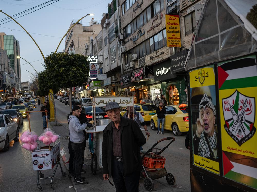 Posters showing late Palestinian Authority leader Yasser Arafat and the Fatah political party's emblem are displayed in Hebron in the occupied West Bank in February.