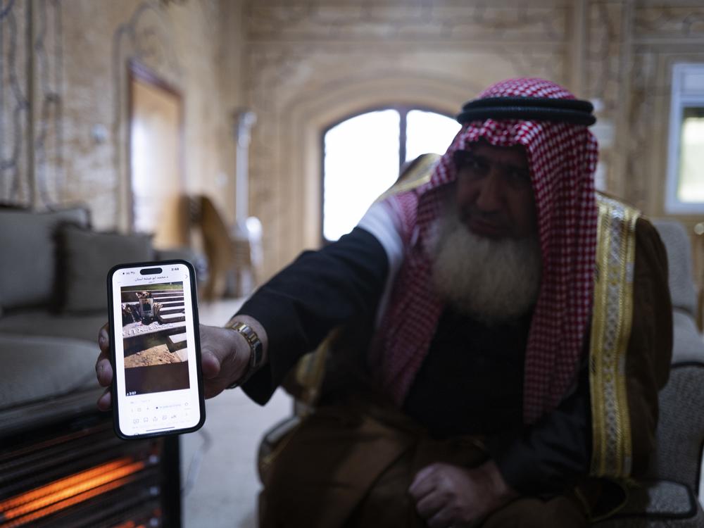 Sheikh Walid Tawil shows a picture of a memorial to Abu Markhiya by gay Palestinian asylum-seekers and their Israeli advocates in Tel Aviv. 