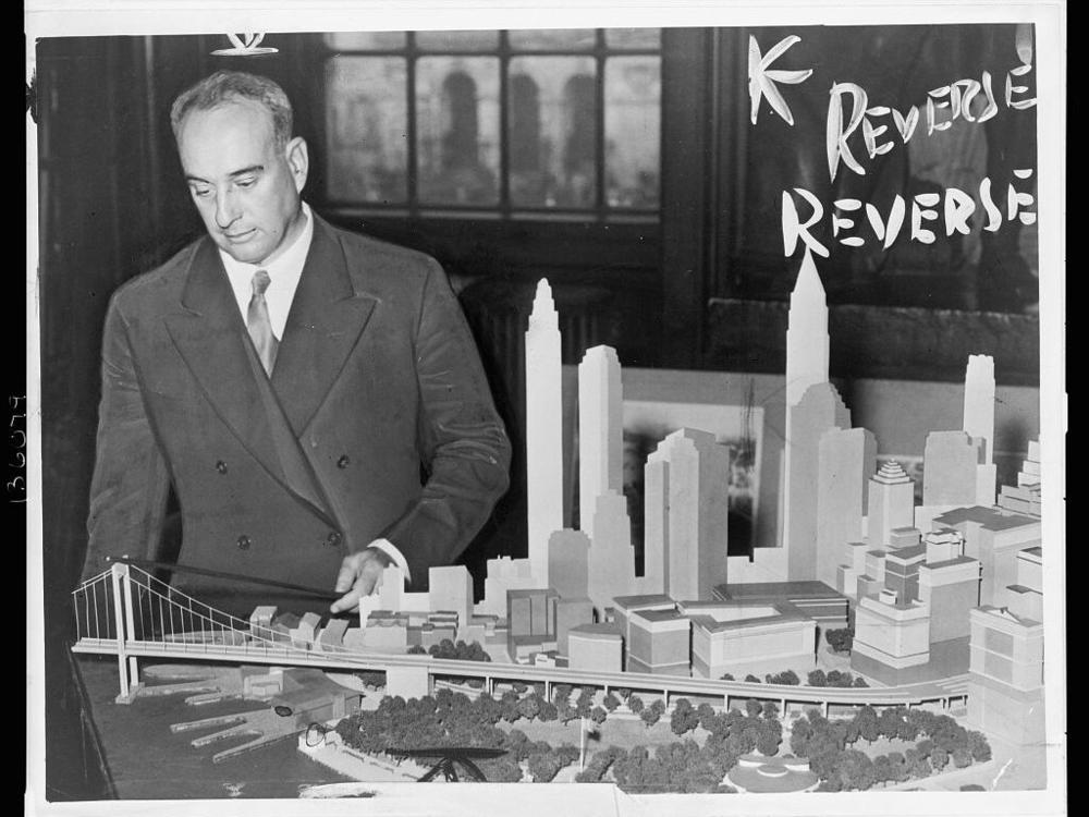 Robert Moses in 1939, then New York City park commissioner, with a model of the proposed Battery Bridge.