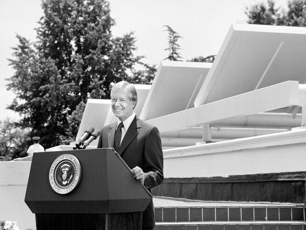 President Jimmy Carter speaks in front of solar panels placed on the West Wing roof of the White House on June 20, 1979. As the U.S. faced an energy crisis in the 1970s, Carter called for Americans to conserve energy and to <a href=