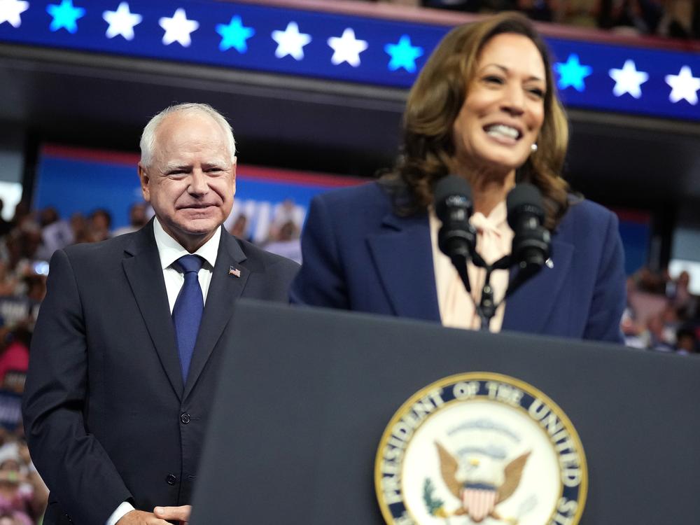 Tim Walz looks on as Vice President Harris speaks during a campaign event on Aug. 6 in Philadelphia. At his upcoming debate against Ohio Sen. JD Vance, Walz will look to frame Harris’ vision for the country, while also having to answer for his own record.