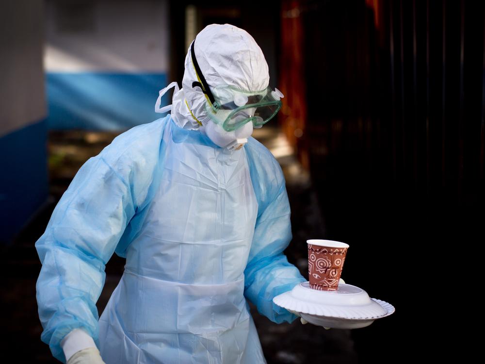 In this 2014 photo, a Kenyan medical worker from the Infection Prevention and Control unit at a Nairobi hospital wears full gear when bringing a meal to a man in quarantine in isolation housing after coming into contact with a carrier of the Marburg virus.