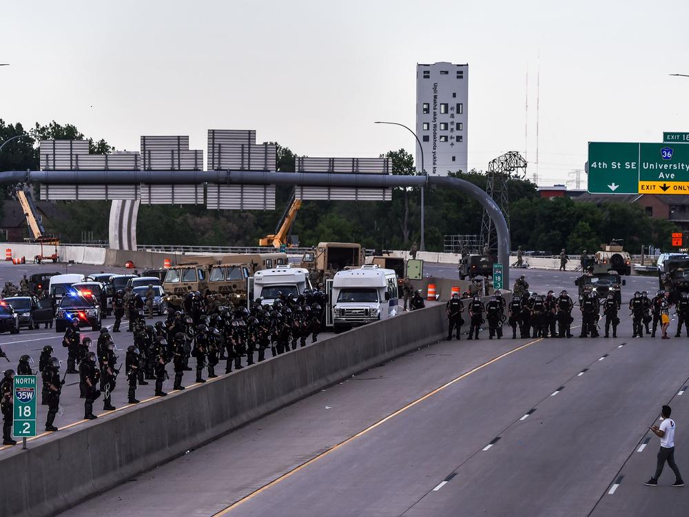 A demonstrator stands in front of the police line during a protest over the death of George Floyd on May 31, 2020 in Minneapolis, Minnesota.