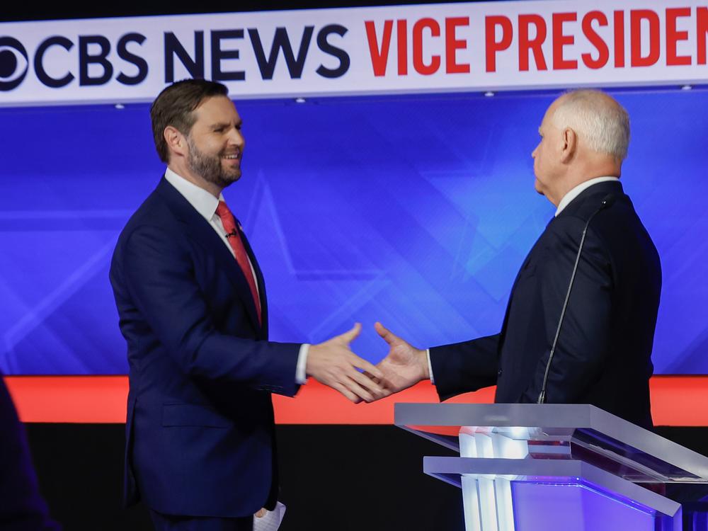 Minnesota Gov. Tim Walz and Ohio Sen. JD Vance shake hands after the vice presidential debate at the CBS Broadcast Center on Tuesday in New York City.