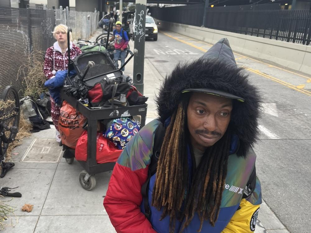 Michael Hood moves on from an illegal homeless encampment that's just been swept by city workers. 