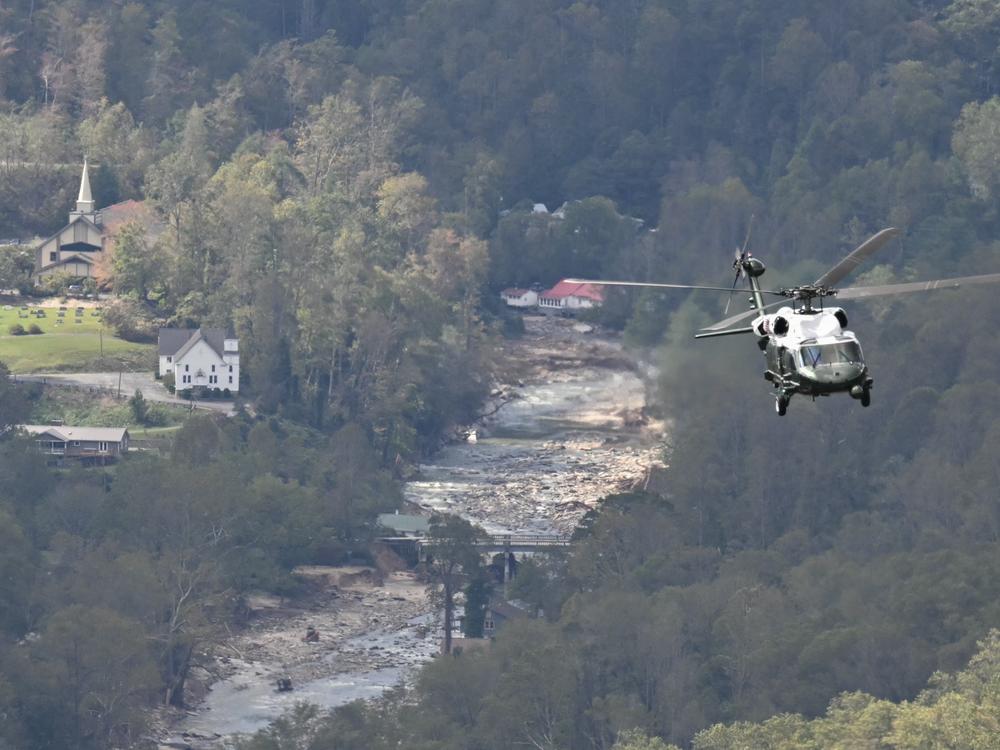 Marine One, carrying President Biden, flies above a storm-impacted area near Asheville, N.C., on Wednesday. Biden was visiting North and South Carolina to survey damage after Hurricane Helene. Social media sites, especially X, were filled with politically charged rumors and conspiracy theories about the hurricane response.