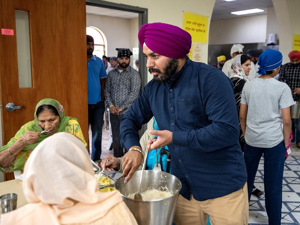 Prabhjot Singh helps serve a meal on a recent Sunday.
