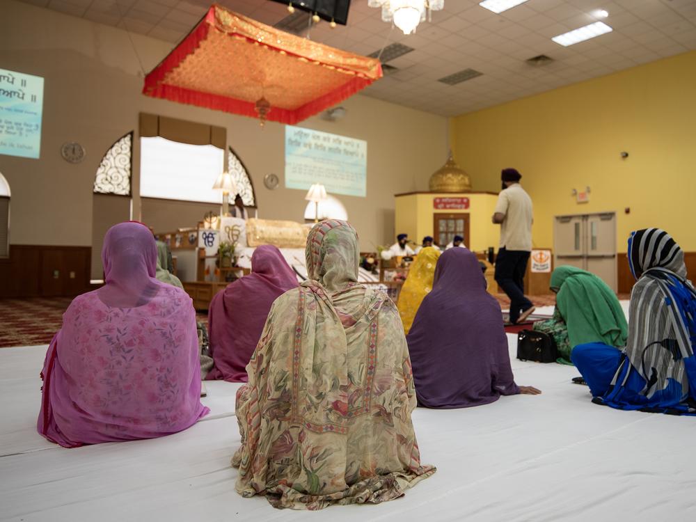 People sit in the prayer hall on a recent Sunday.