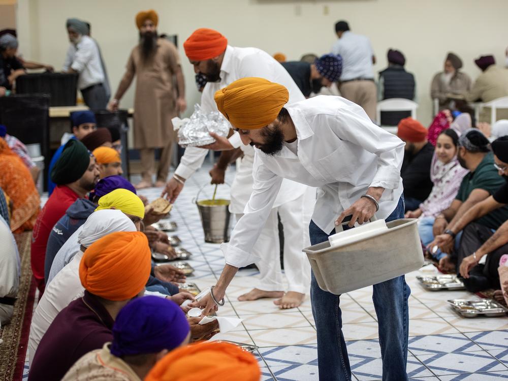 Temple attendees enjoy food prepared by congregation members.