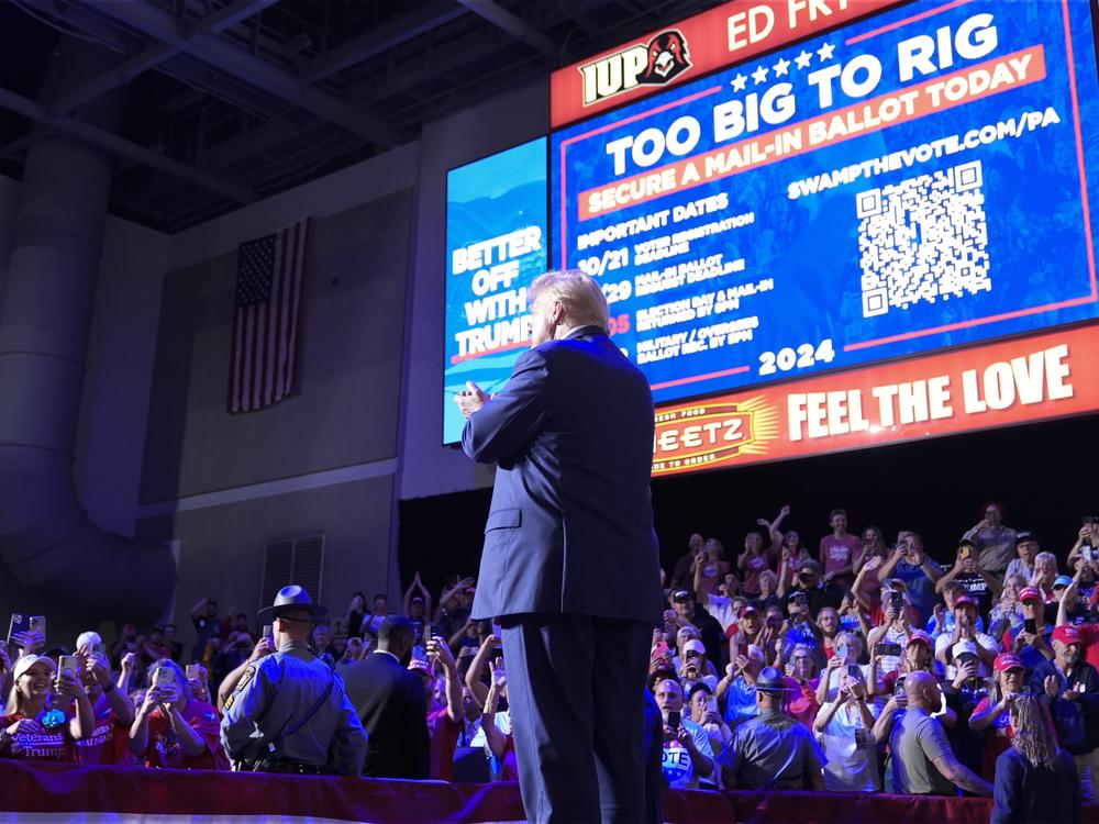 Former President Donald Trump stands on stage after speaking at a campaign event in Indiana, Pa., on Sept. 23. Behind Trump, Republicans are urged to vote in numbers that are 