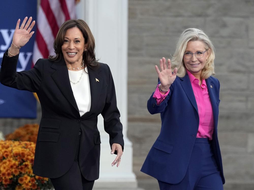 Vice President Harris walks with former Rep. Liz Cheney, R-Wyo., at a campaign rally in Ripon, Wis. on Oct. 3.