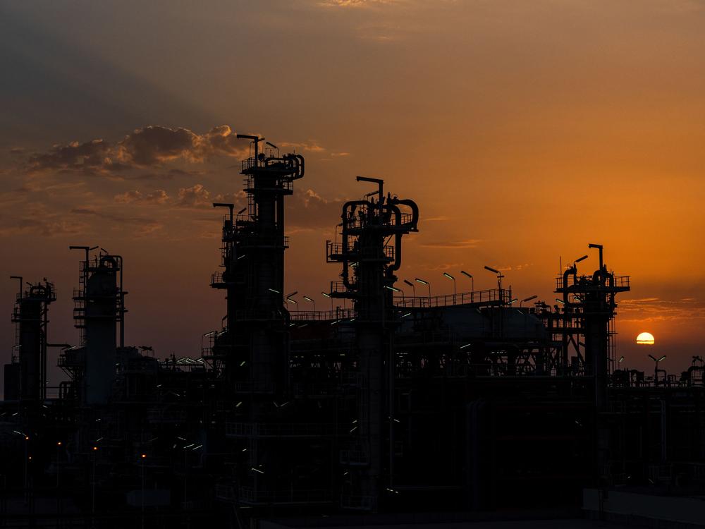 The sun shines behind a refinery in the South Pars Gas-Condensate field in Asalouyeh Seaport in Iran. Iran's oil and natural gas infrastructure is a possible target for Israeli attacks as tensions in the Mideast mount.  Oil prices have risen as a result — but remain relatively low, compared to most of 2024.