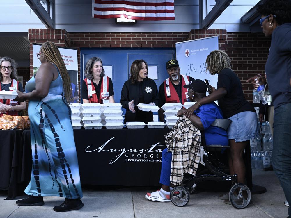 Vice President Harris hands out food to people at the Henry Brigham Community Center in Augusta, Ga., on Oct. 2, during a tour of hurricane damage in the area.