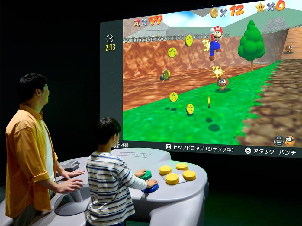 Visitors to the Nintendo Museum can play classic games together on giant controllers.