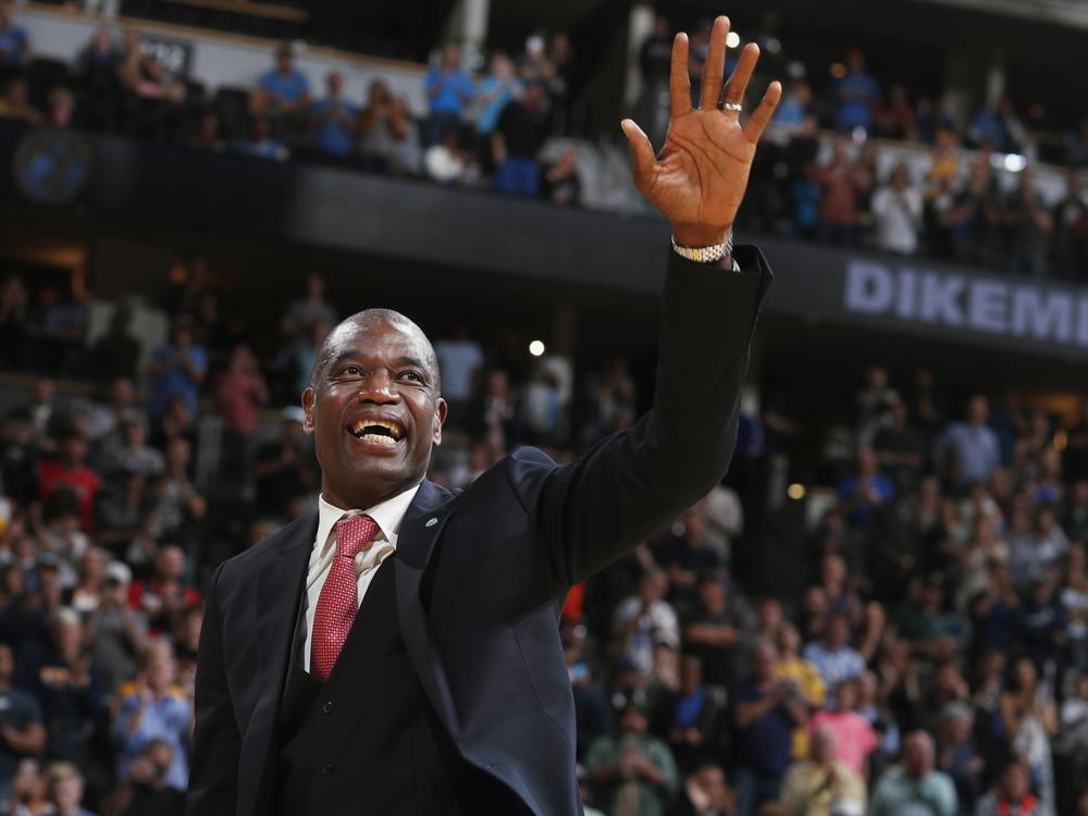 Retired Denver Nuggets center Dikembe Mutombo waves to the crowd as his jersey number was retired by the team during halftime of the Nuggets' NBA basketball game against the Portland Trail Blazers on Saturday, Oct. 29, 2016, in Denver.