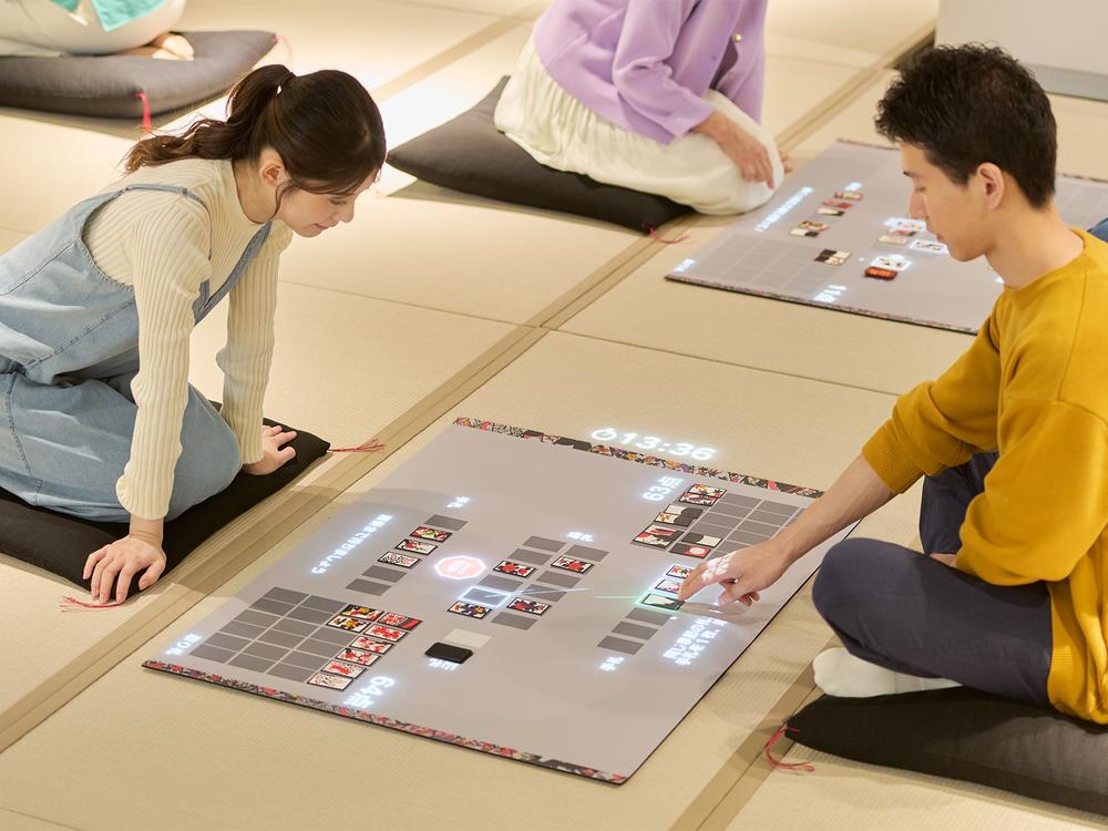 Museum visitors play a digital version of hanafuda, the traditional card game that Nintendo manufactured in its early years.