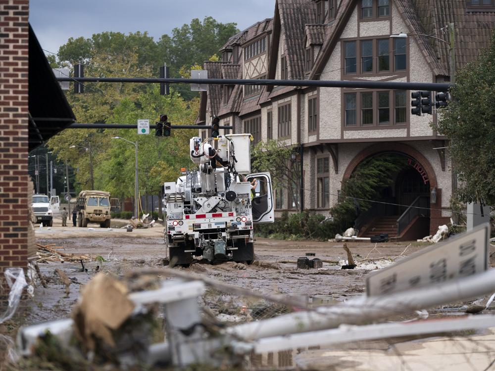 A Duke Energy lineman works on a line the Biltmore Village in the aftermath of Hurricane Helene on Sept. 28 in Asheville, N.C.