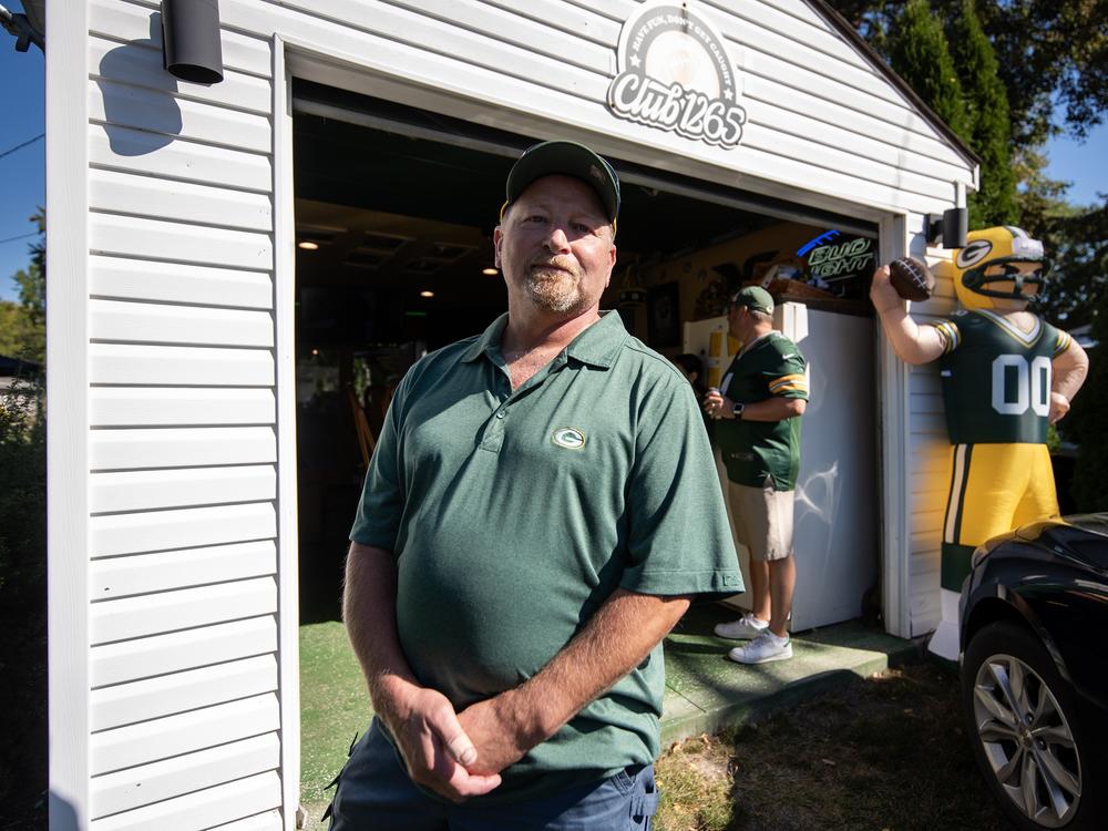 Green Bay Packers fan Bud Hearley stands outside a garage turned into a bar in a neighborhood near Lambeau Field on Sunday, Sept. 29, before the Packers’ game against the Minnesota Vikings.