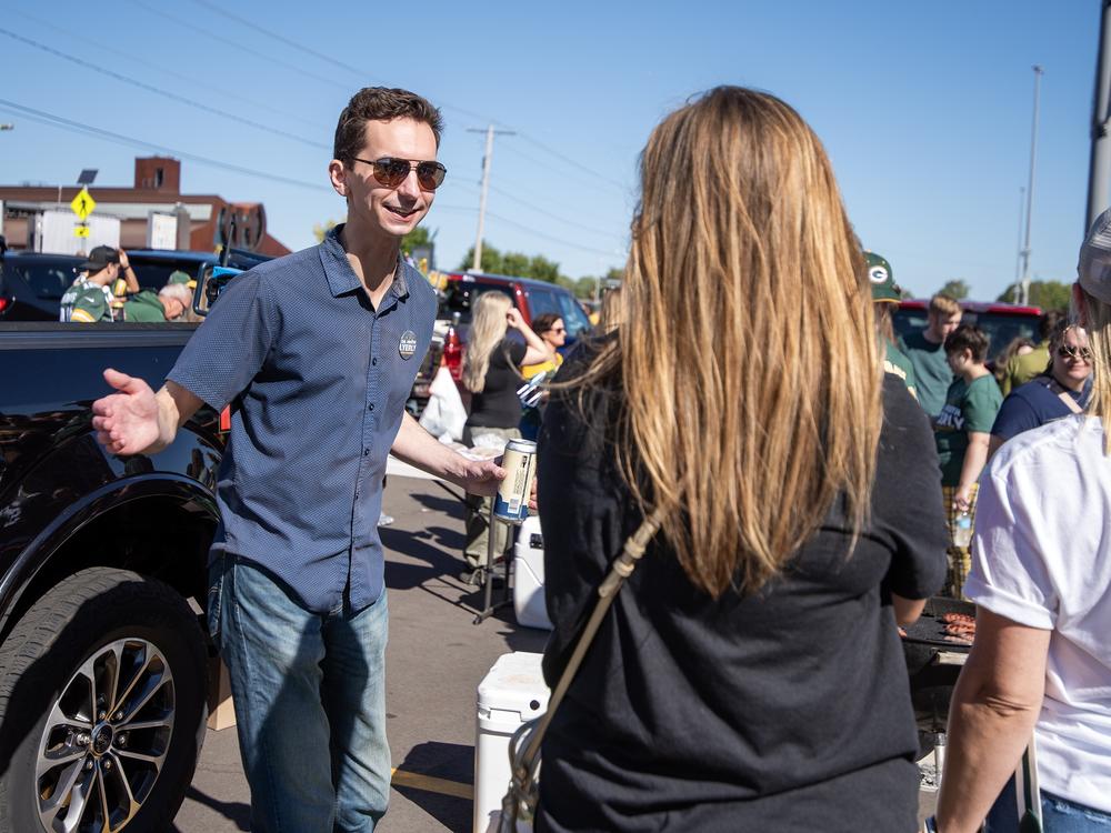 Wisconsin Assembly Candidate Ryan Spaude mingles with voters and other Democrats at a tailgate Sunday, Sept. 29, outside of Lambeau Field.