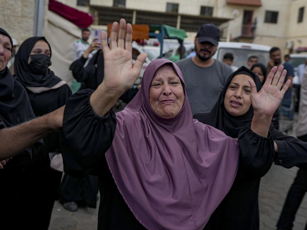Palestinians mourn relatives killed in the Israeli bombardment of the Gaza Strip, at a hospital in the Gaza town of Deir al-Balah, on Oct. 1, 2024.