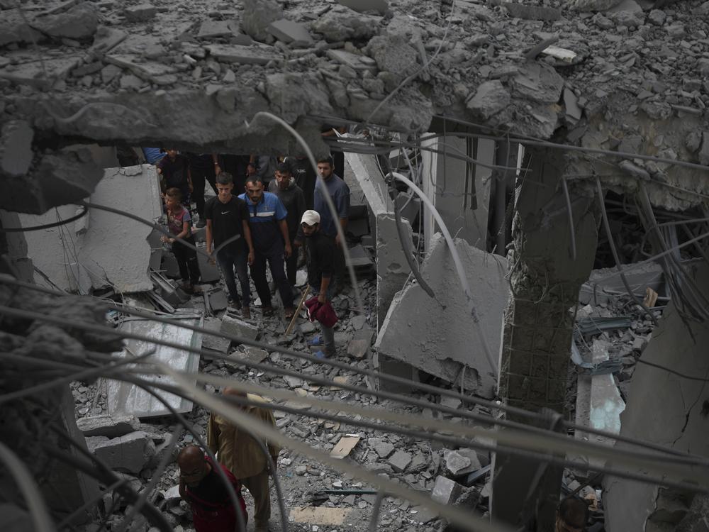 Palestinians examine a destroyed mosque following an Israeli airstrike in Deir al-Balah, on Sunday.