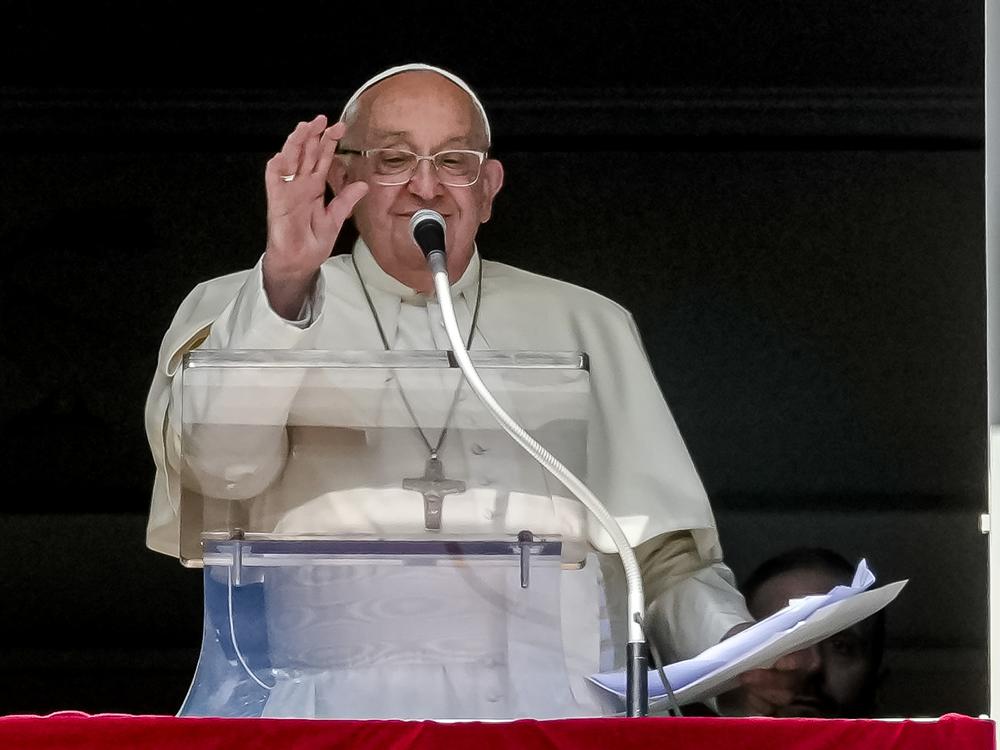 Pope Francis appears at his studio window for the traditional noon blessing of faithful and pilgrims gathered in St. Peter's Square at The Vatican, Sunday, Oct. 6, 2024.