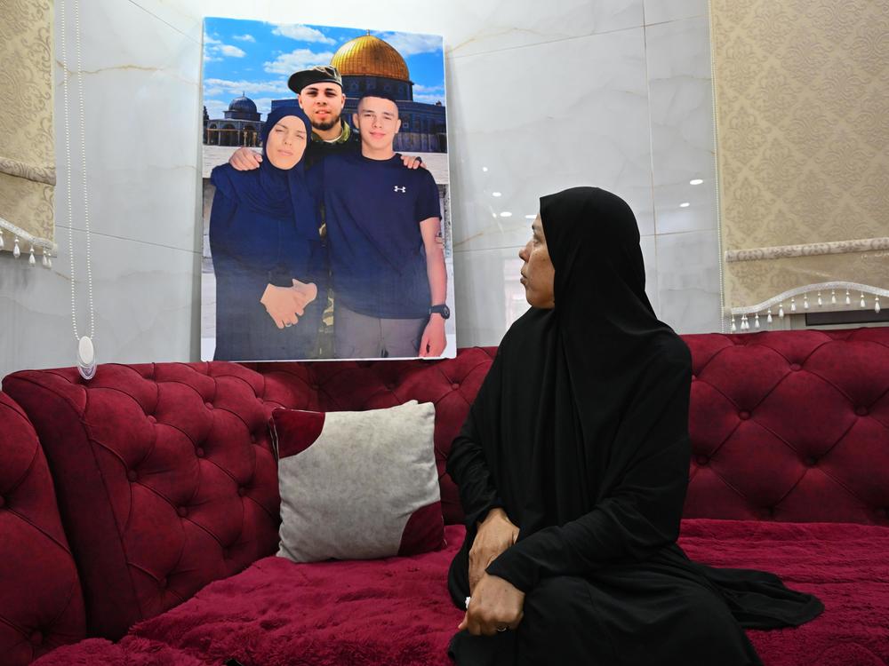 Two of Jameel Amori's sons wer killed in the Jenin refugee camp in the Israeli-occupied West Bank. She sits among memories, including some superimposed images of the three of them together, with a wistful backdrop of the Dome of the Rock holy site in Jerusalem.