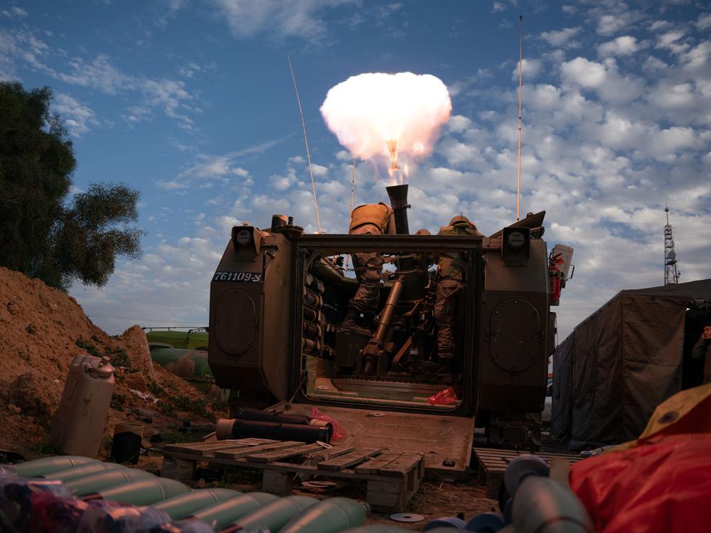 Israeli soldiers prepare and fire mortars from inside Israel into Gaza, backing up troops near the Maghazi refugee camp, where three attacks occurred that killed a combined 21 Israeli soldiers, on Jan. 22.