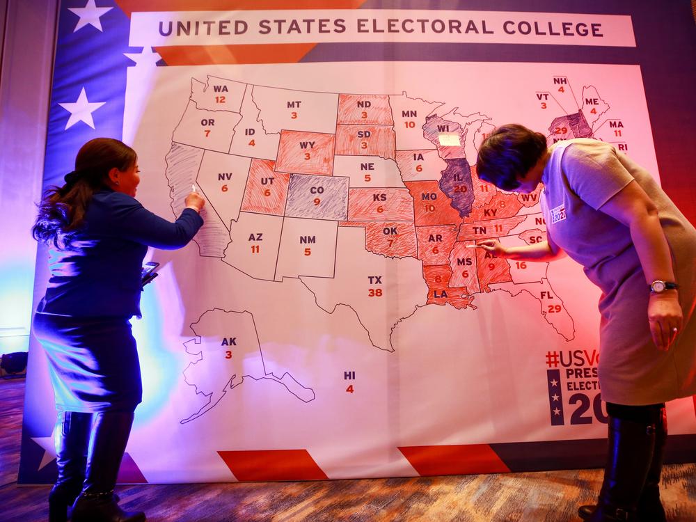 People color in a U.S. electoral map during a 2020 presidential election watch party at the U.S. Embassy in Ulaanbaatar, Mongolia.
