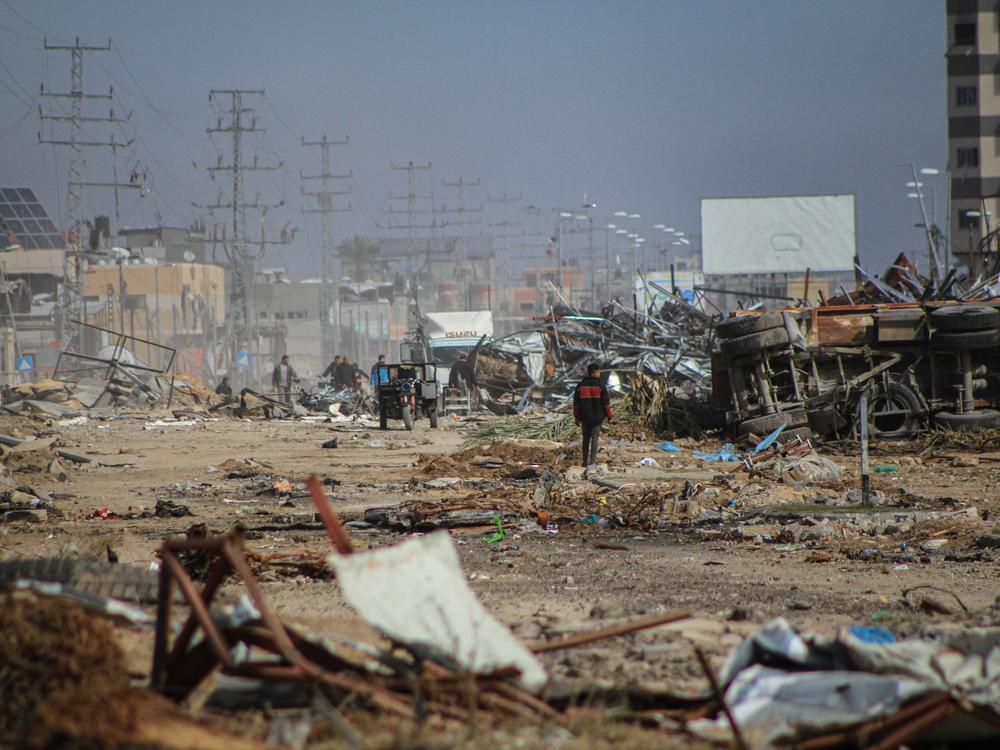Palestinians among the rubble of destroyed buildings at the Maghazi refugee camp in southern Gaza Strip, on Jan. 21.
