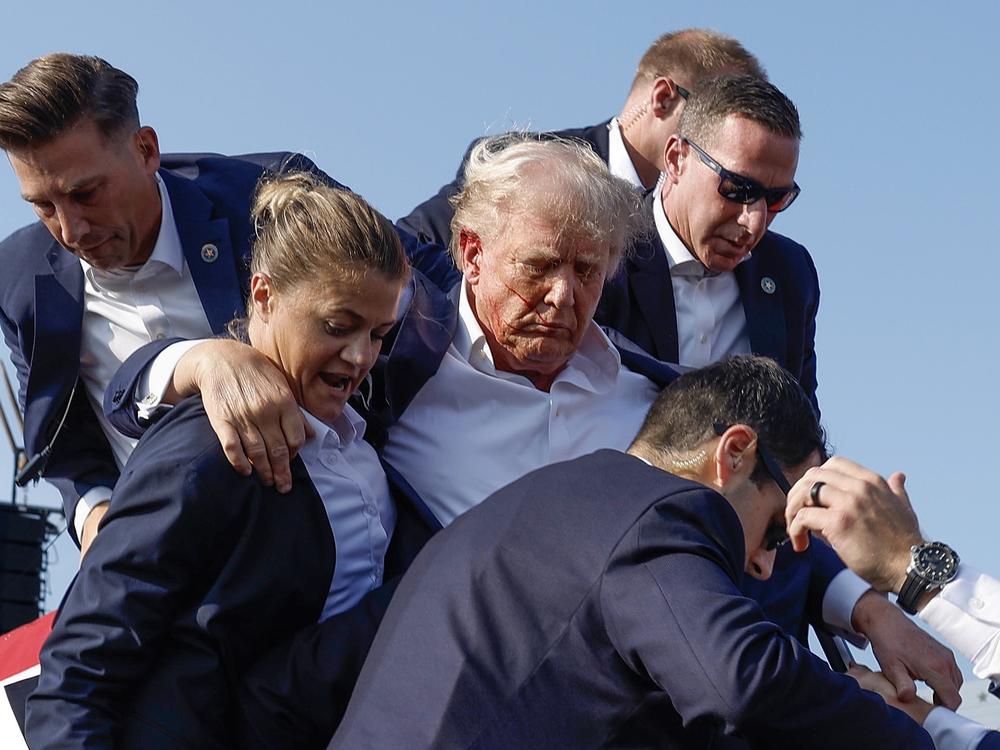 Former President Donald Trump is rushed offstage by U.S. Secret Service agents after being grazed by a bullet during a rally on July 13 in Butler, Pa.