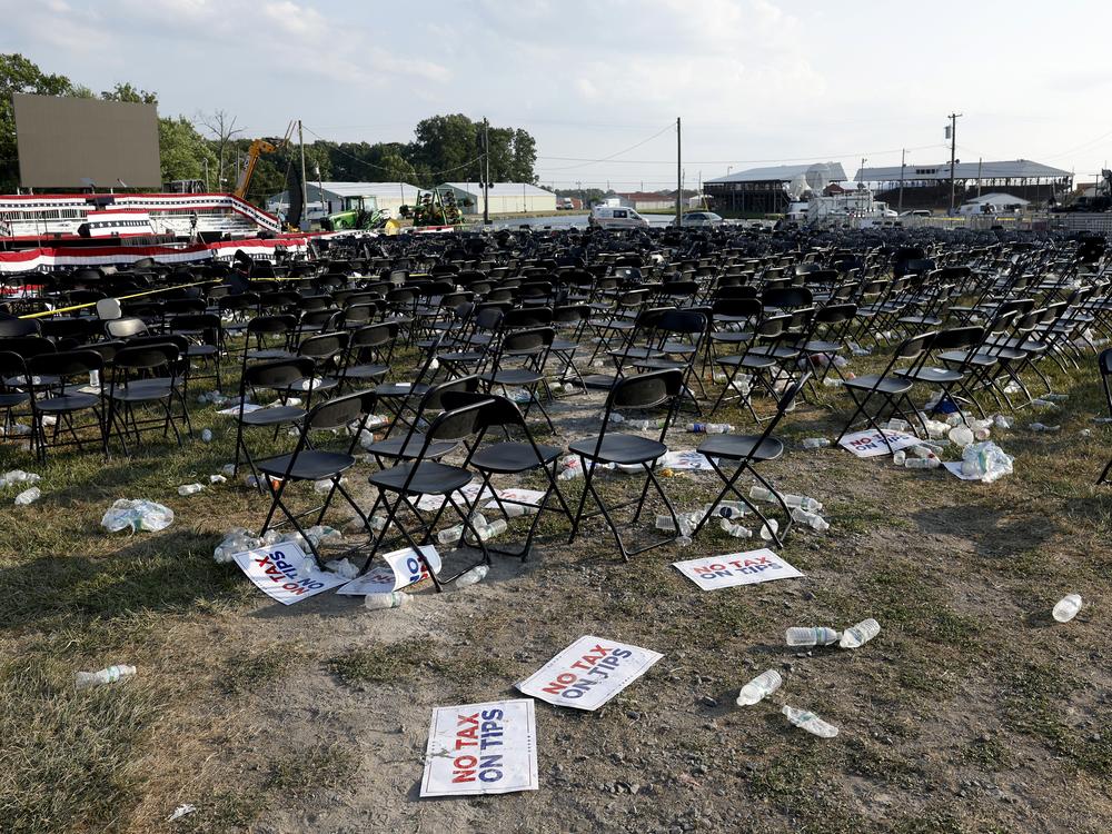 Campaign signs and empty water bottles are seen on the ground in the aftermath of the assassination attempt in Butler.