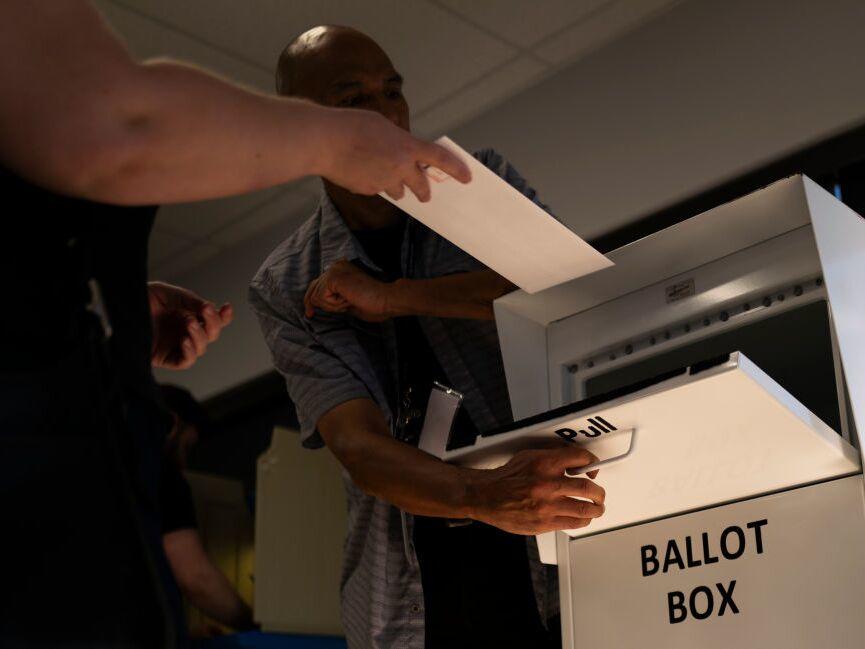 A voter drops their ballot into a ballot box in Minneapolis on Sept. 20.