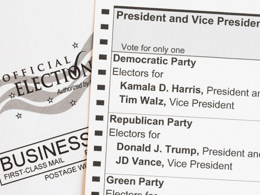 In this photo illustration, an absentee-voter mail-in ballot shows the names of the Democratic and Republican presidential and vice presidential candidates in the 2024 election.