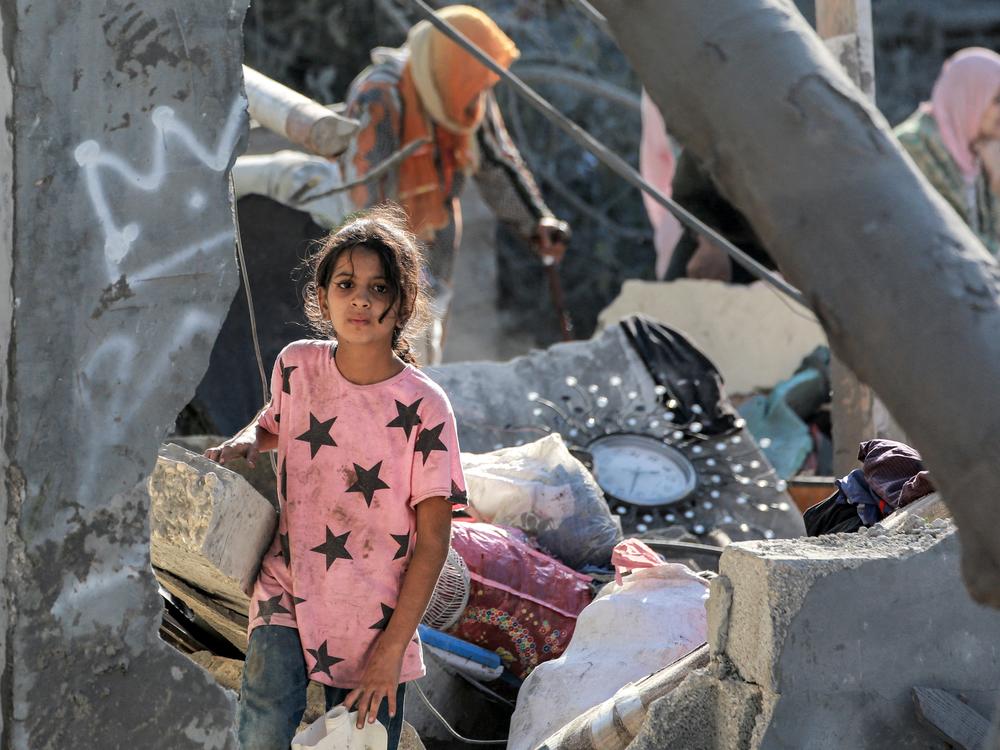 A girl walks through the rubble of a collapsed building in Khan Younis, in the southern Gaza Strip, on Oct. 2, amid the war in the Palestinian territory between Israel and Hamas.