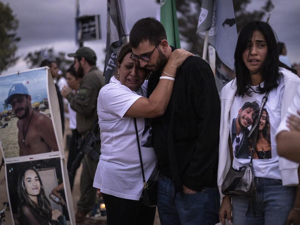Two people embrace as relatives and supporters of Israelis killed in the Oct. 7, 2023 Hamas attack attend a ceremony at the Nova memorial near Kibbutz Reim in southern Israel on Oct. 7, 2024.