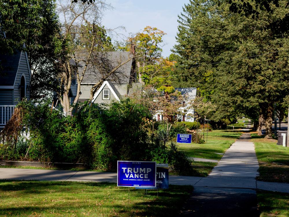 A Trump and Harris sign side-by-side in a neighborhood on Oct. 3, 2024 in Hillsdale, Mich.