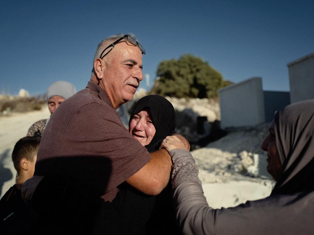 Palestinian farmer Ayoub Abu Hejleh is reunited with his family after being detained for hours by Israeli forces in the occupied West Bank in November 2023.