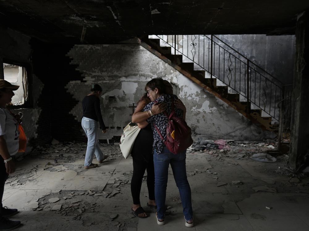 People hug at the house of Maayan and Yuval Bar killed by Hamas, as Israel marks the one-year anniversary of the Hamas attack on Israel, at the Kibbutz Be'eri, an Israeli communal farm on the Gaza border on Monday.
