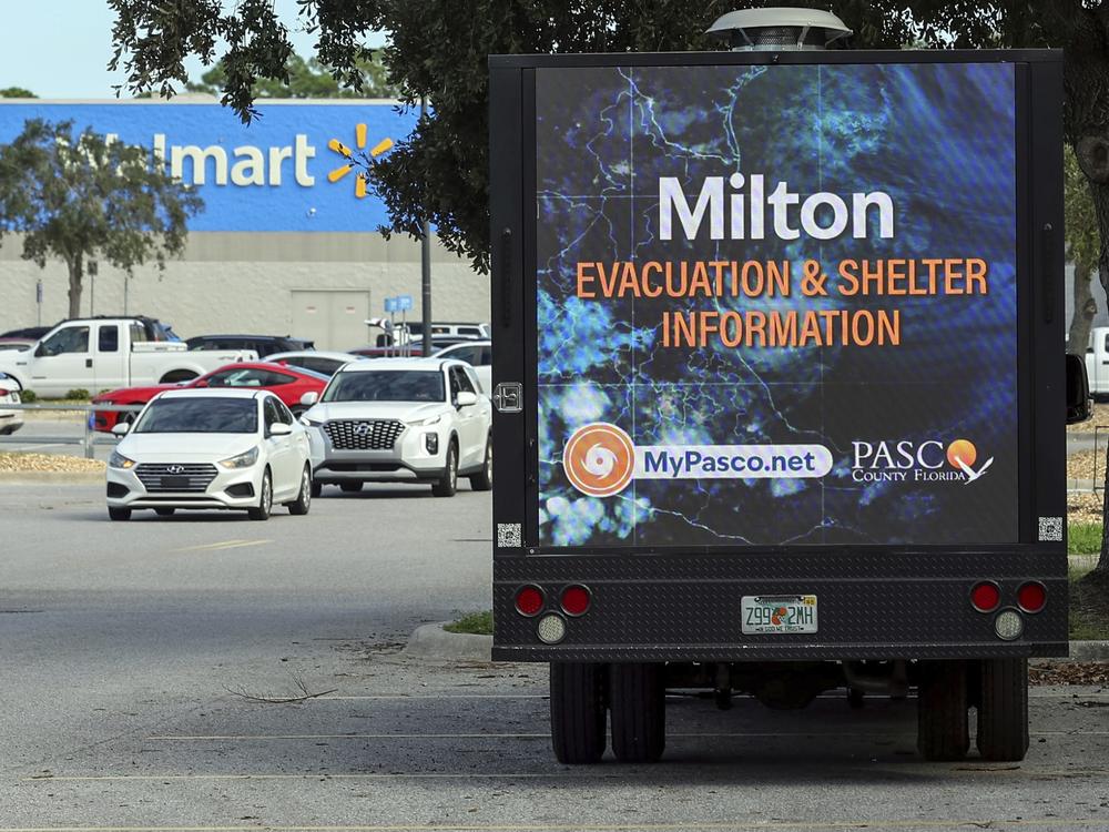 An LED signage truck with loudspeakers makes announcements informing residents of mandatory evacuations in preparation for Hurricane Milton on Tuesday in Port Richey, Fla.