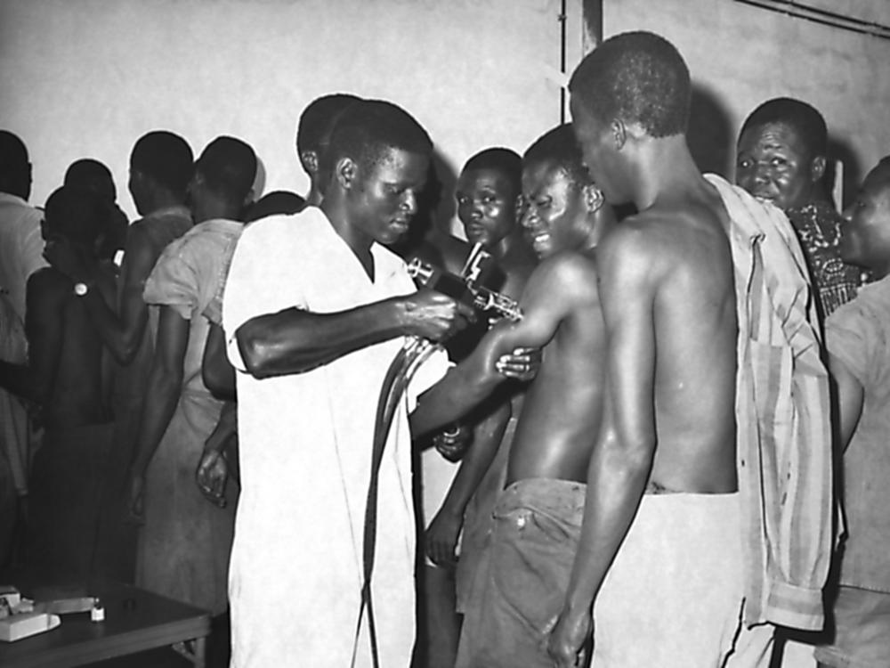 Global Smallpox Eradication worker vaccinating a group of local residents, Contonou, Benin, 1968. Image courtesy Centers for Disease Control (CDC). (Photo by Smith Collection/Gado/Getty Images)