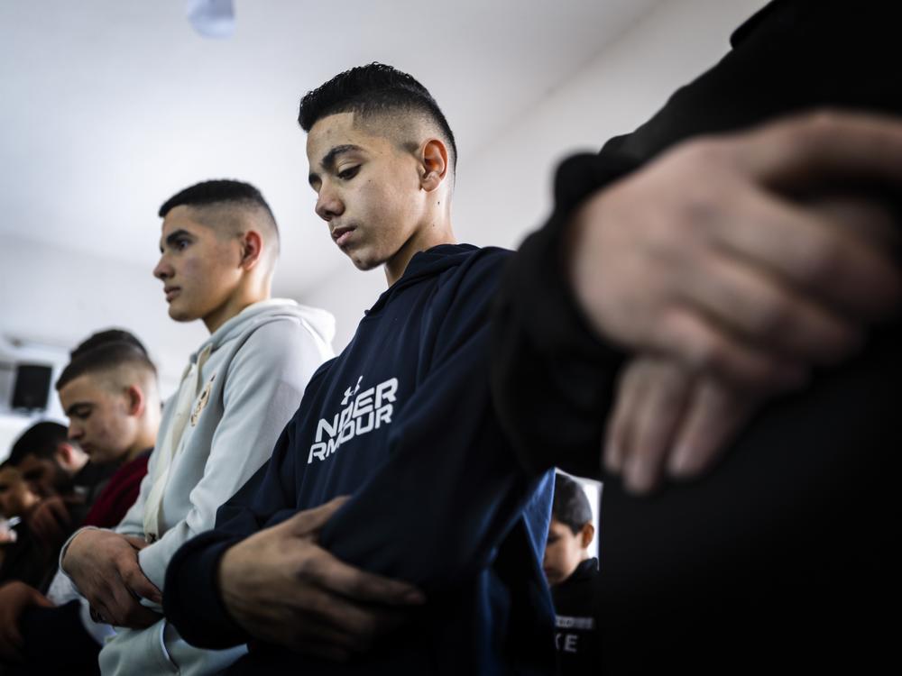 Noor Assi prays in his local mosque. He has devoted himself to faith, family and his work.