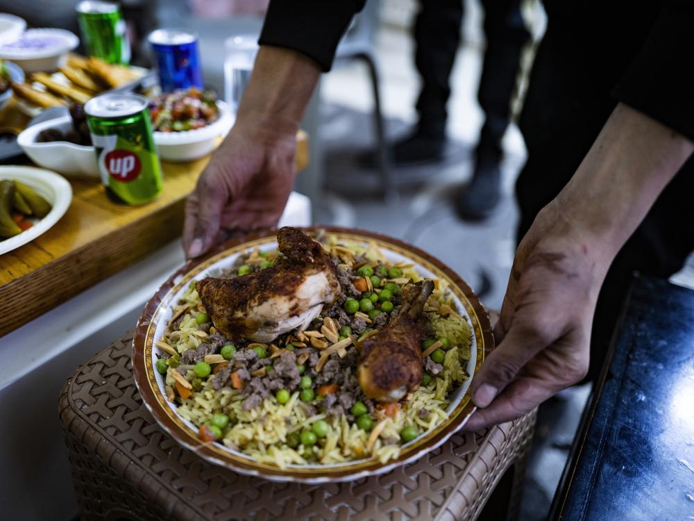 Noor serves his family food after breaking the fast during the Muslim holy month of Ramadan.